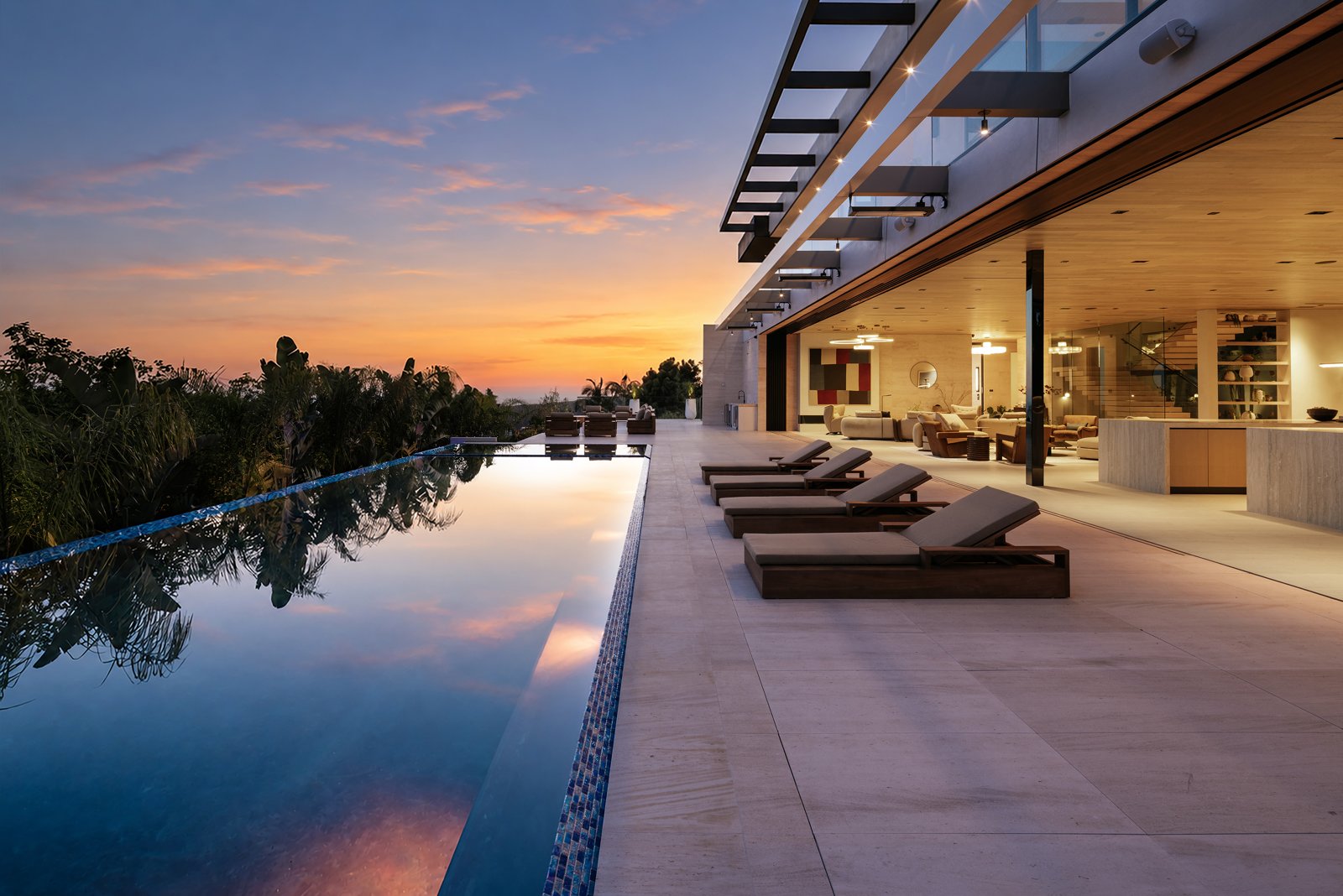 1210 Chickory Lane’s infinity pool and open living area at sunset